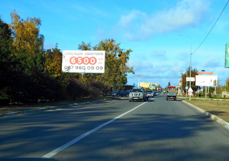 Билборд Гостомель,  смт. Гостомель, вул. Свято-Покровська, 3-А, навпроти повороту на вул. Вербицького, перед Алеєю Слави, перед Ринком