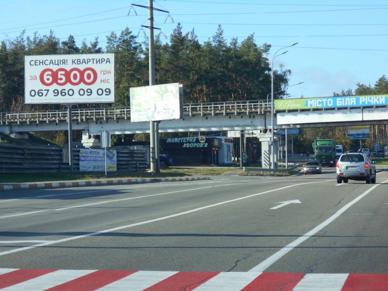 Billboard Gostomel,  м. Ірпінь-м. Гостомель, вул. Свято- Покровська (навпроти №22-А) - вул. Шевченка, траса М-07, км 23+700 ліво, перед Гостомельським кільцем, біля Сіті Маркету, зупинка