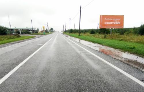 Билборд A в Рава-Русской, 6x3м.  Кордон, на кордон з респ. Польща, автодорога Львів - Рава - Руська (М-09) + АЗК + жовта вітрозахисна рамка фото 1