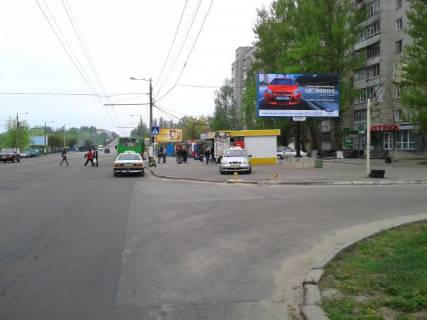 Билборд A в Житомире, 6x3  Миру просп., 37 (Мікрорайон ДОС, АТБ, аптека "Первоцвіт-Фарм", ПРОДМАРКЕТ "Проспект", ОщадБанк), в напрямку центра міста фото 1