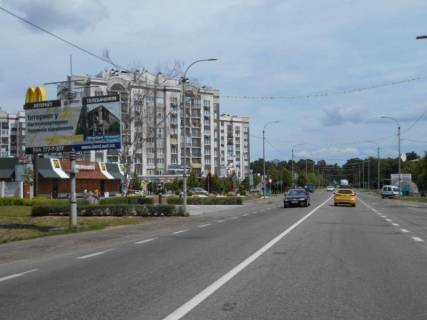 Билборд B в Буче, 6х3  м. Буча, траса М-07 "Київ-Ковель", км 28+300 право, вул. Нове Шосе, біля автобусної зупинки та McDonald's, навпроти магазину ЕКО-Маркет, за 400м до магазину Novus та поворту на вул. Вокзальна, через 180м після перехрестя з вул. Вишнева та вул. фото 1