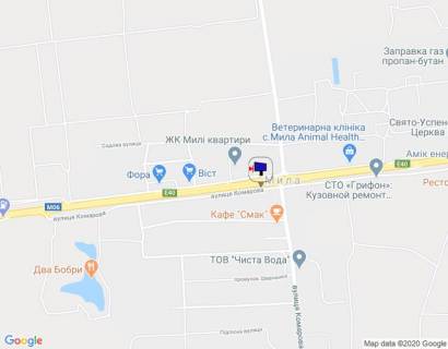 Billboard A in With. Mila s. Mila, trasa M-06 Kiiv-Cop (Zitomir), km 25+770 livo, bila avtobusnoi zupinki, pered zamis'kim kompleksom "Car'grad", pered povorotom na Petruski, cerez 400m pisla magazinu "Fora" scheme