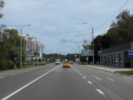 Білборд, Бігборд (Борд)  A у Бучі, 6х3  м. Буча, траса М-07 "Київ-Ковель", км 28+300 ліво, вул. Нове Шосе, біля автобусної зупинки та магазину ЕКО-Маркет, навпроти McDonald's, за 400м до магазину Novus та поворту на вул. Вокзальна, через 180м після перехрестя з вул. Вишнева та вул. Польова Фото 1